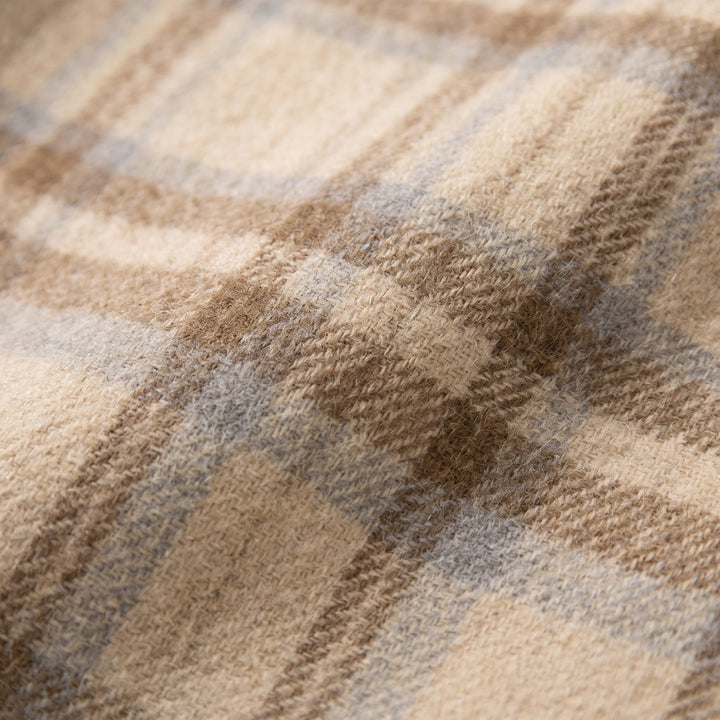 Close-up of the beige plaid wool fabric