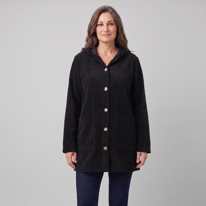 Woman wearing a black corduroy hooded jacket, front view