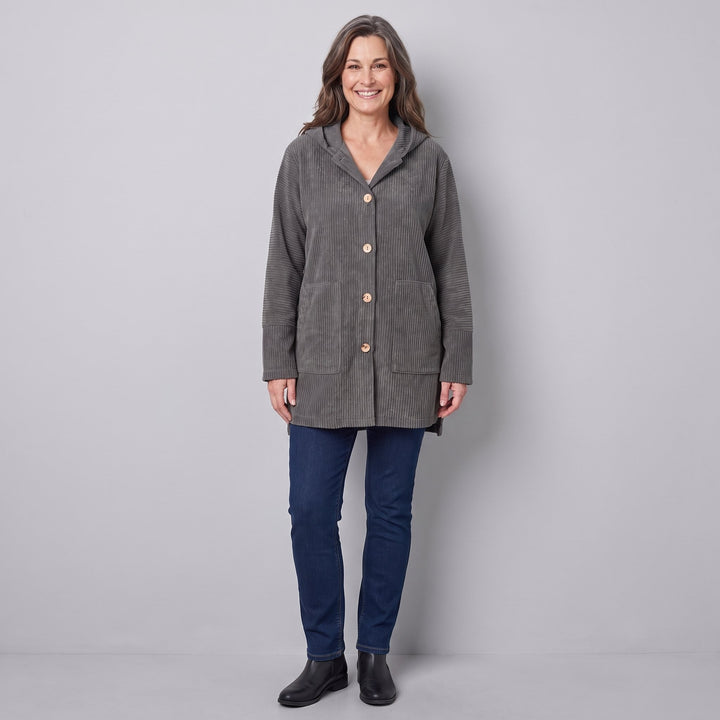 Woman wearing a grey corduroy hooded jacket, front view