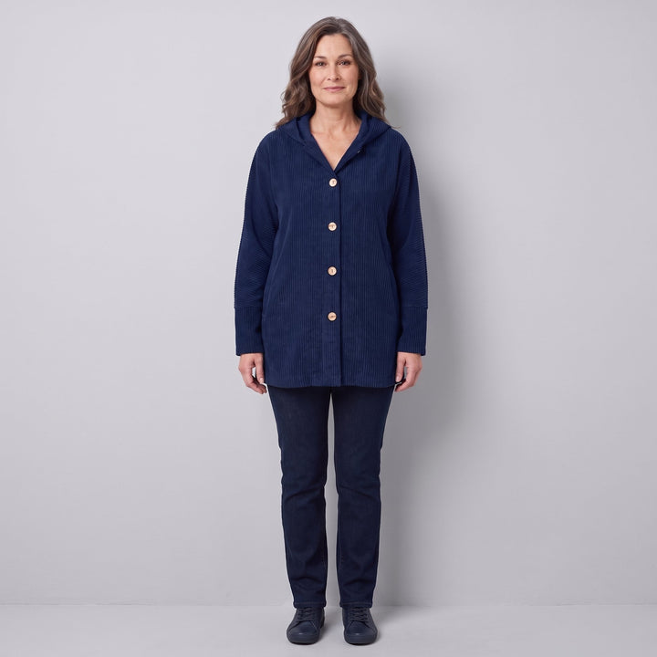 Woman wearing a navy blue corduroy hooded jacket, front view