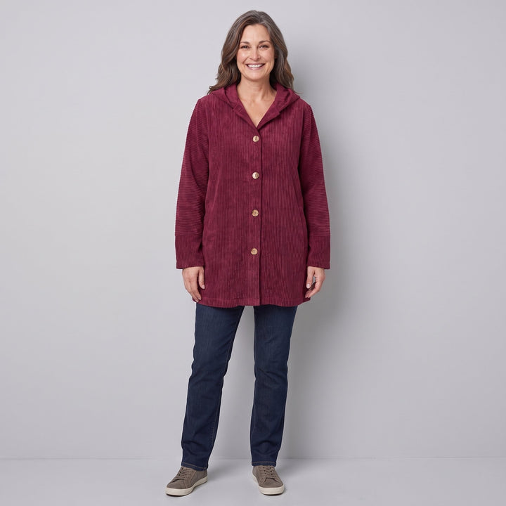 Woman wearing a burgundy corduroy hooded jacket, front view