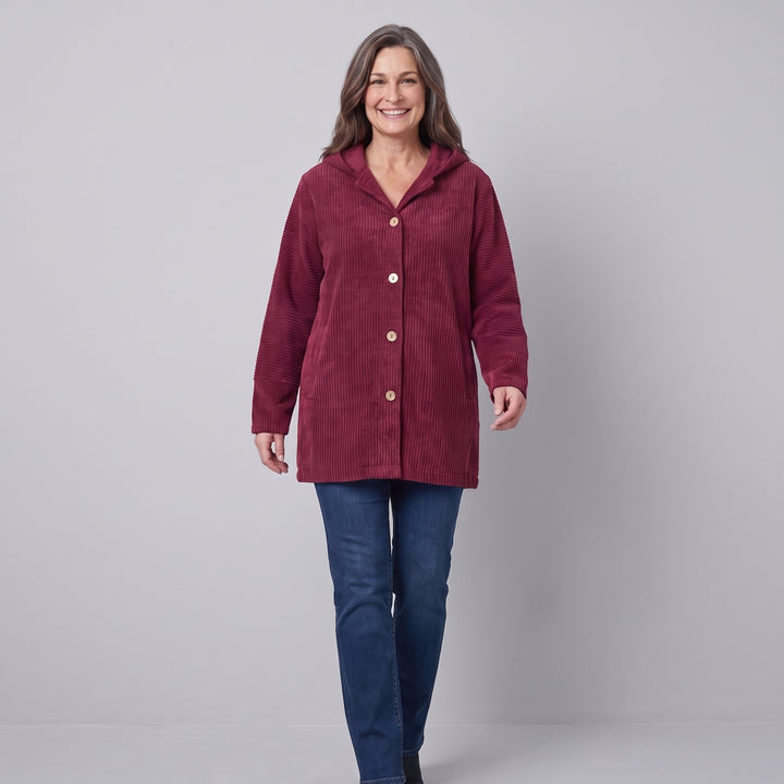 Burgundy corduroy hooded jacket in a walking pose