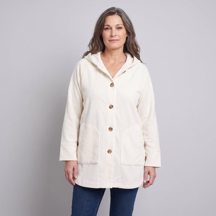 Woman wearing a cream corduroy hooded jacket, front view