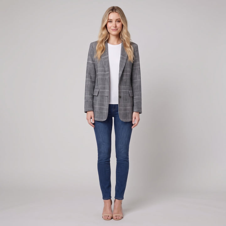 Woman wearing a grey-and-black glen-check blazer, front view