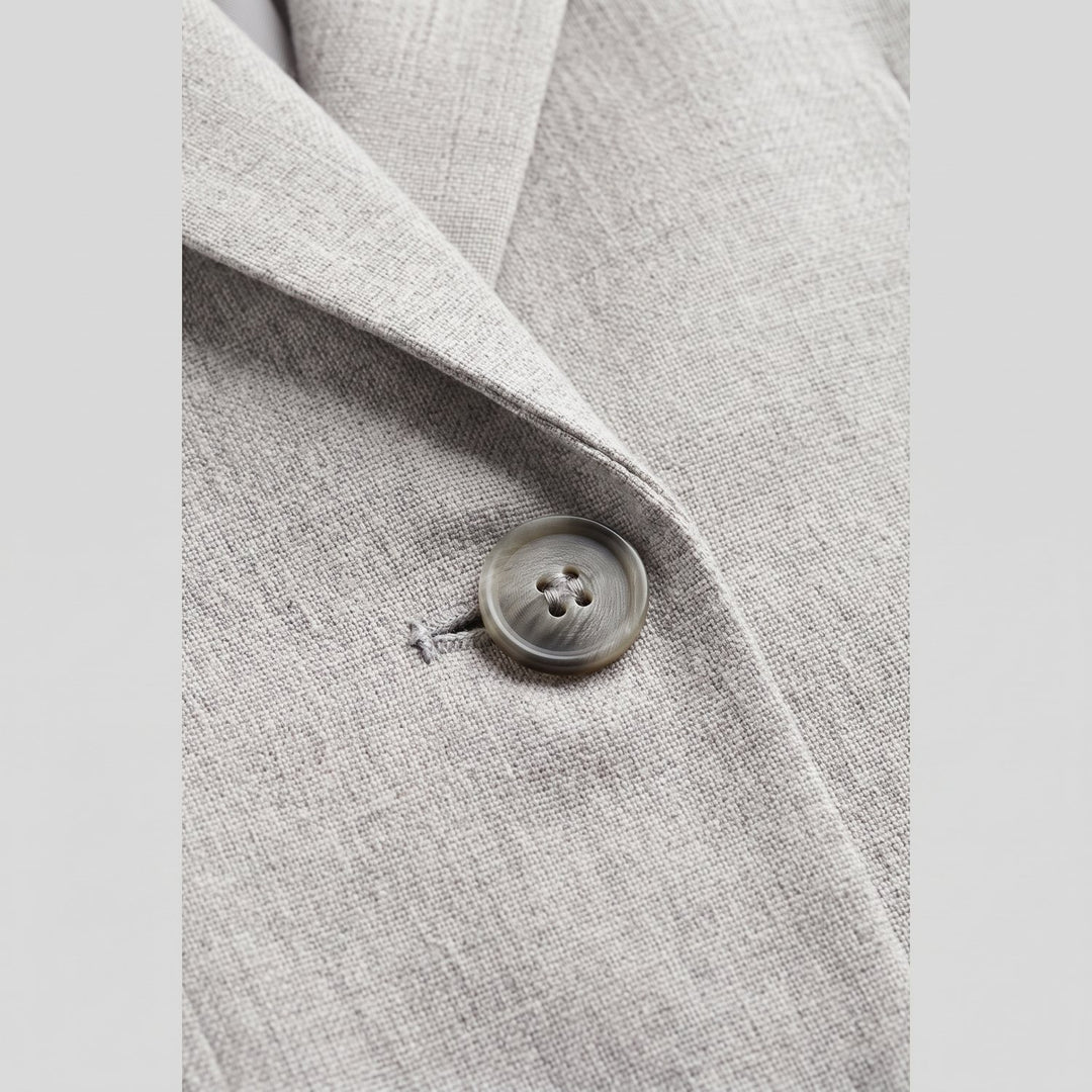 Women's grey tailored blazer fabric close-up
