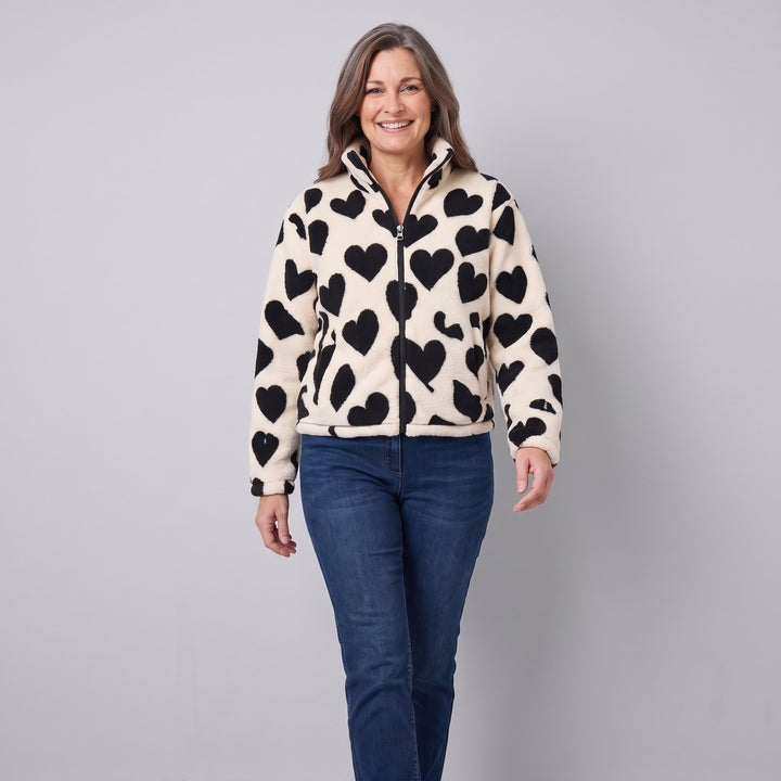 Cream sherpa heart jacket in a walking pose