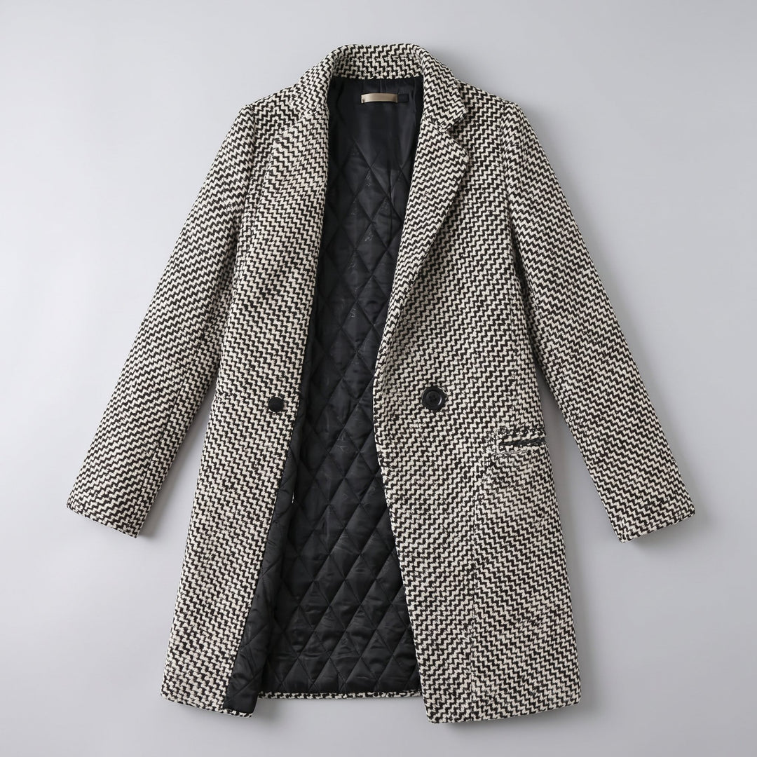 Flat-lay of the herringbone tailored coat on grey background