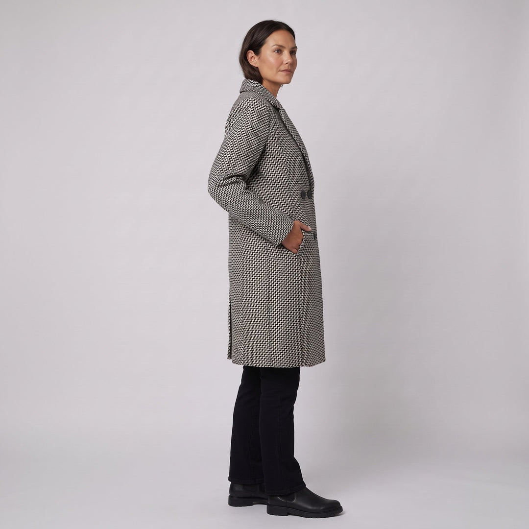 Herringbone wool coat three-quarter side view with hand in pocket