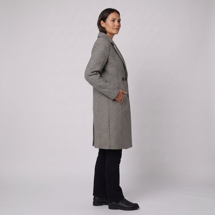 Herringbone wool coat three-quarter side view with hand in pocket