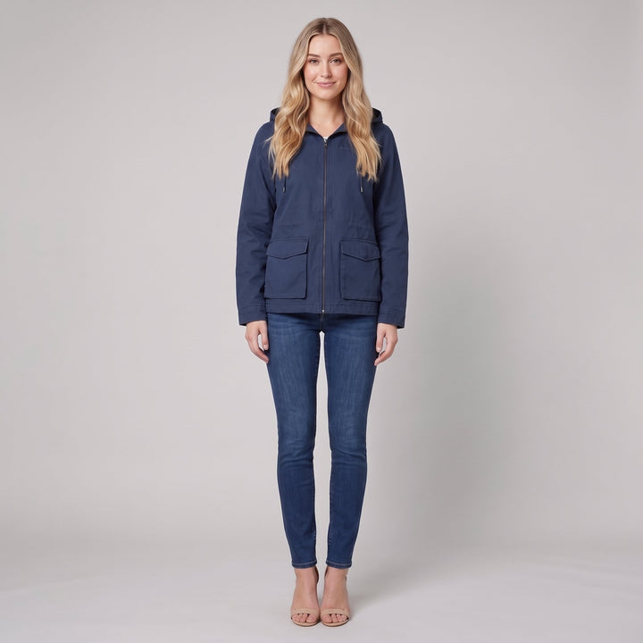 Woman wearing a navy blue canvas hooded field jacket, front view