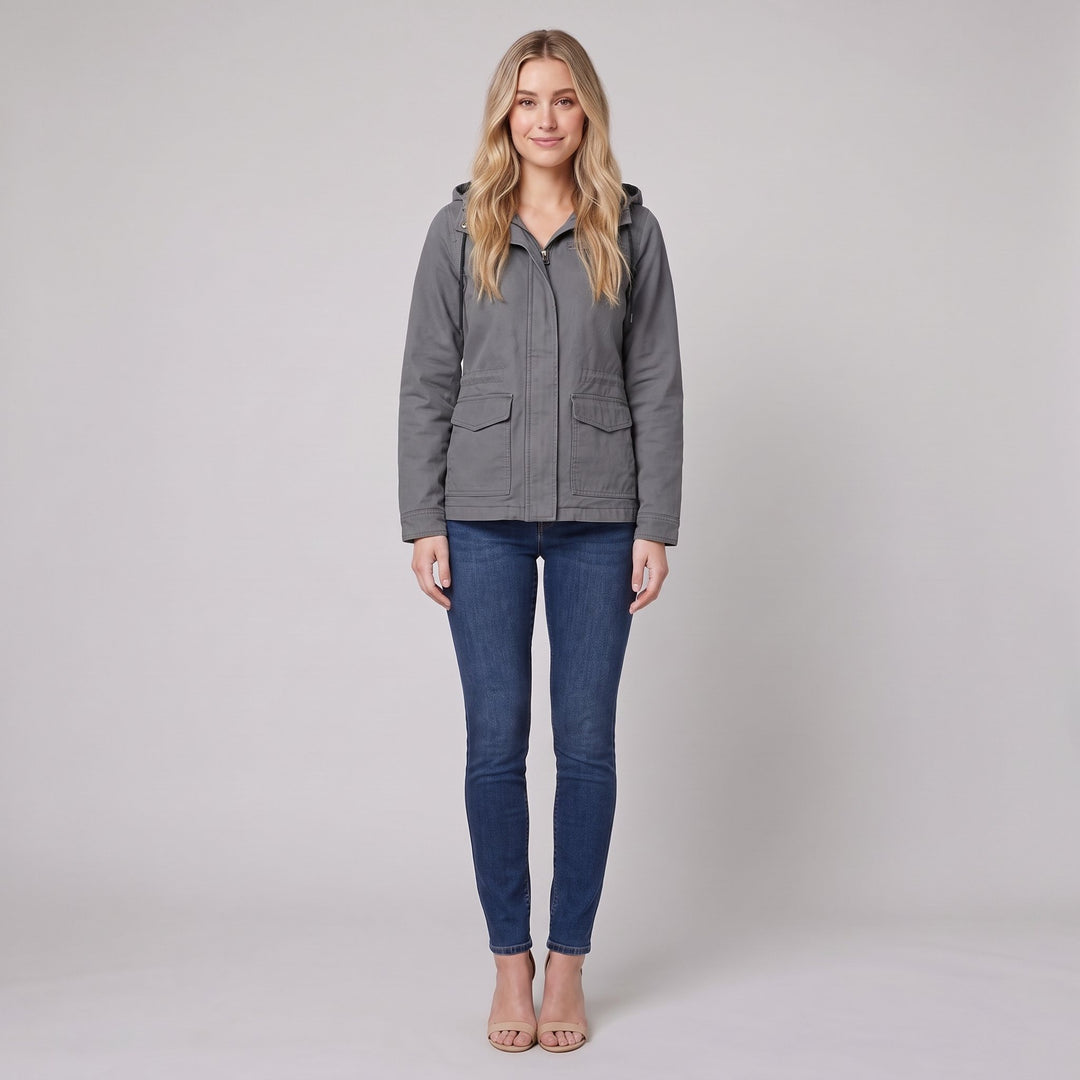 Woman wearing a grey canvas hooded field jacket, front view