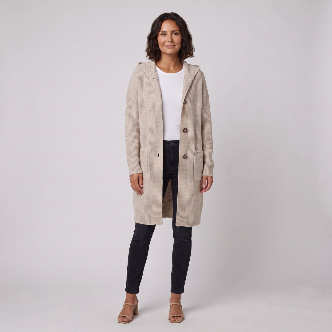Woman wearing a long beige hooded knit cardigan-coat, front view