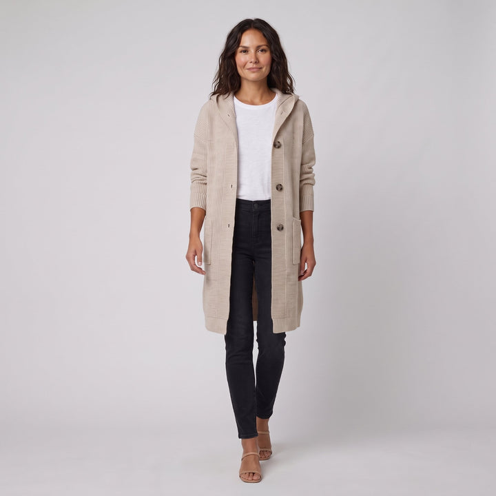 Beige hooded knit cardigan-coat in a walking pose