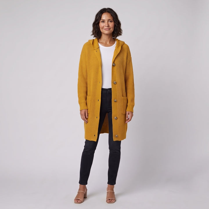 Woman wearing a mustard yellow hooded knit cardigan-coat, front view