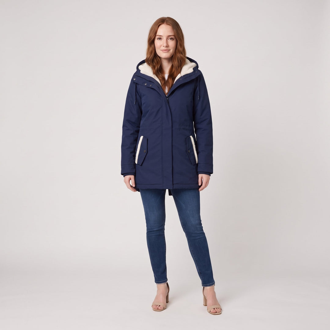 Woman wearing a navy blue fleece-lined hooded parka, front view