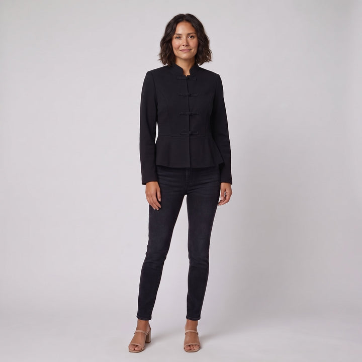 Woman wearing a black stand-collar tailored jacket, front view