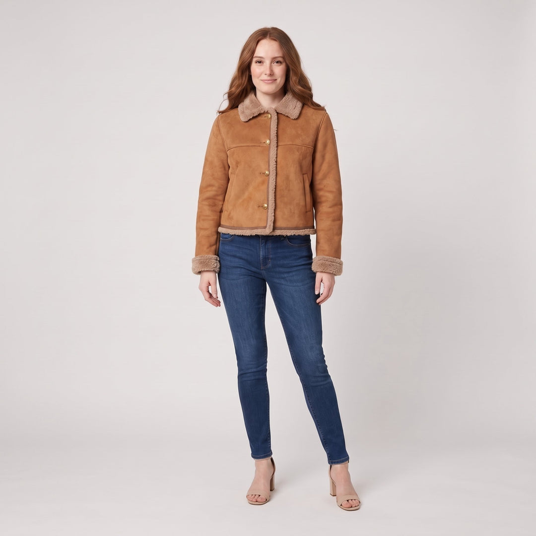 Woman wearing a brown suede shearling-lined jacket, front view