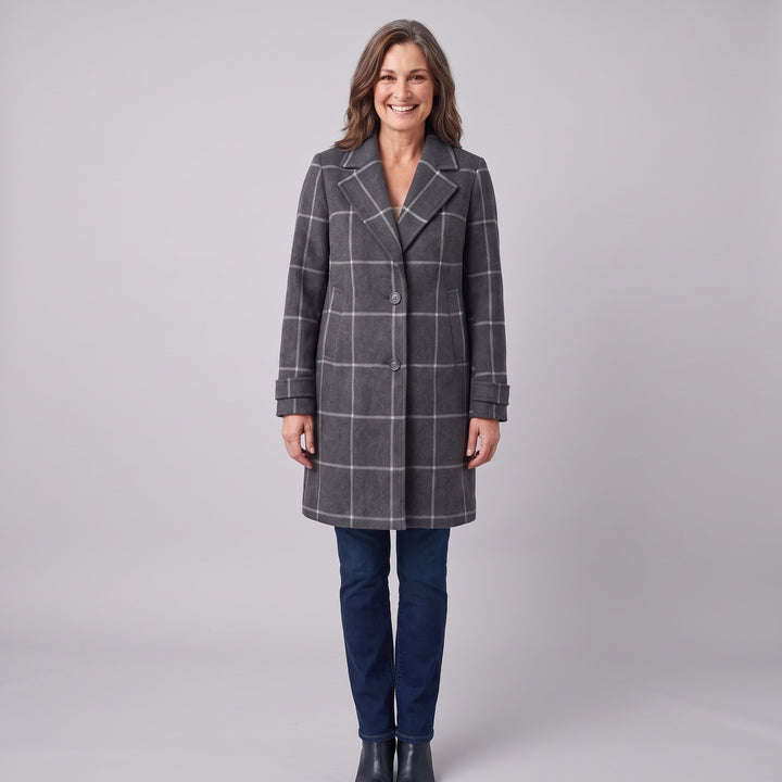 Woman wearing a grey windowpane check wool coat, front view