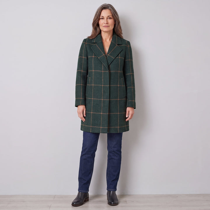 Woman wearing a dark green windowpane check wool coat, front view