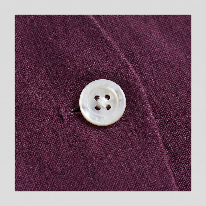 Blythe aubergine vest fabric close-up with button detail