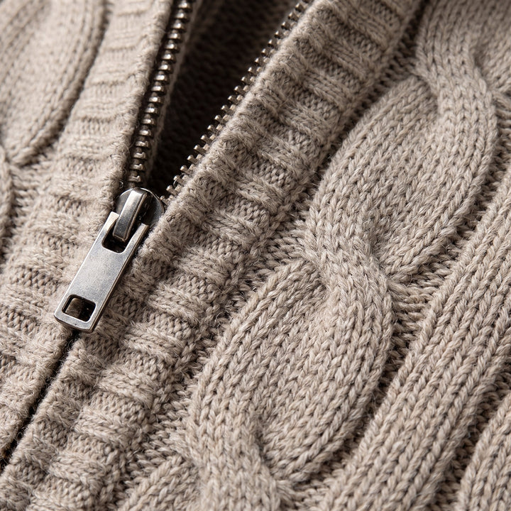 Cable knit vest fabric and zipper close-up