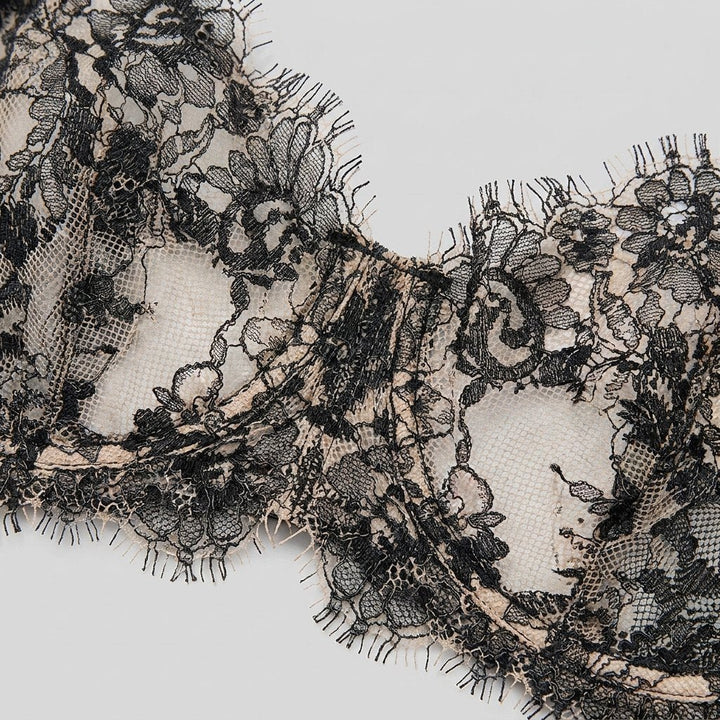 Close-up of the eyelash scalloped lace edge on the navy balconette bra