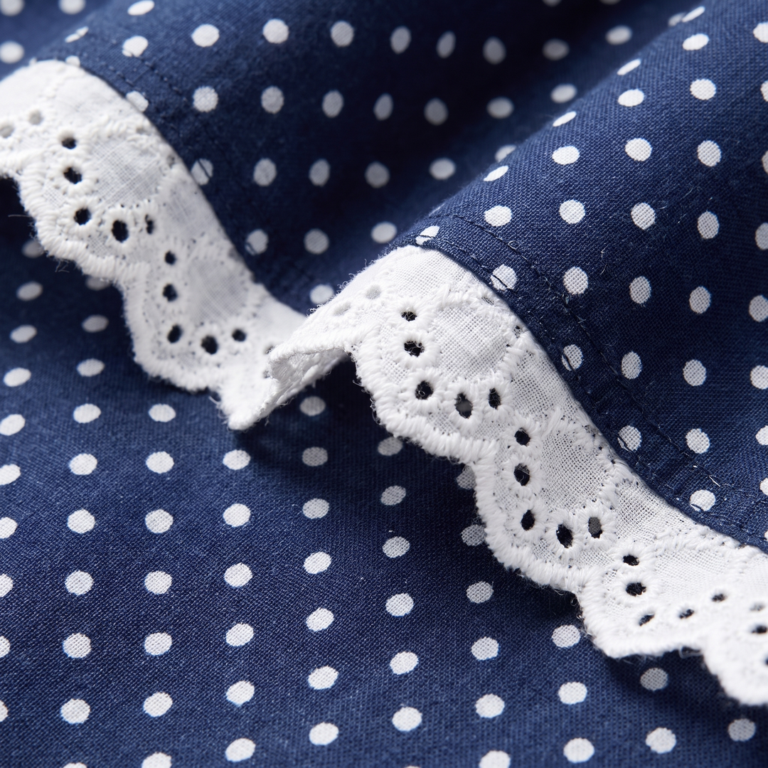 Close-up of the lace-trimmed collar and gathered puff sleeve on the Ellen mini dress