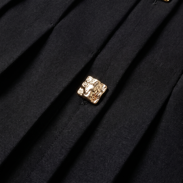 Evangeline black pleated fabric and gold button detail