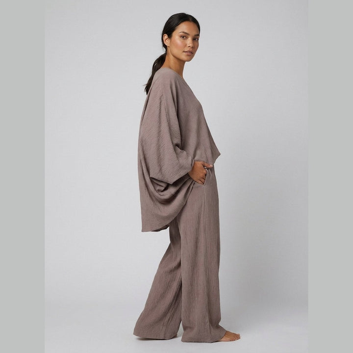 Taupe batwing sleeve top and ankle pants, side view on model