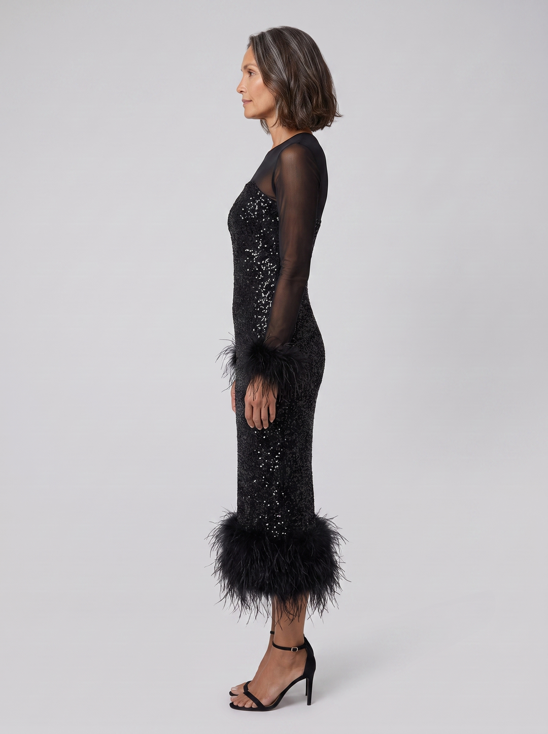 Black sequin midi dress, side view on model