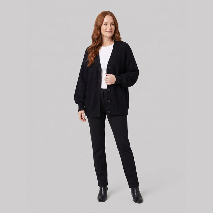Black oversized boucle cardigan on model, relaxed pose