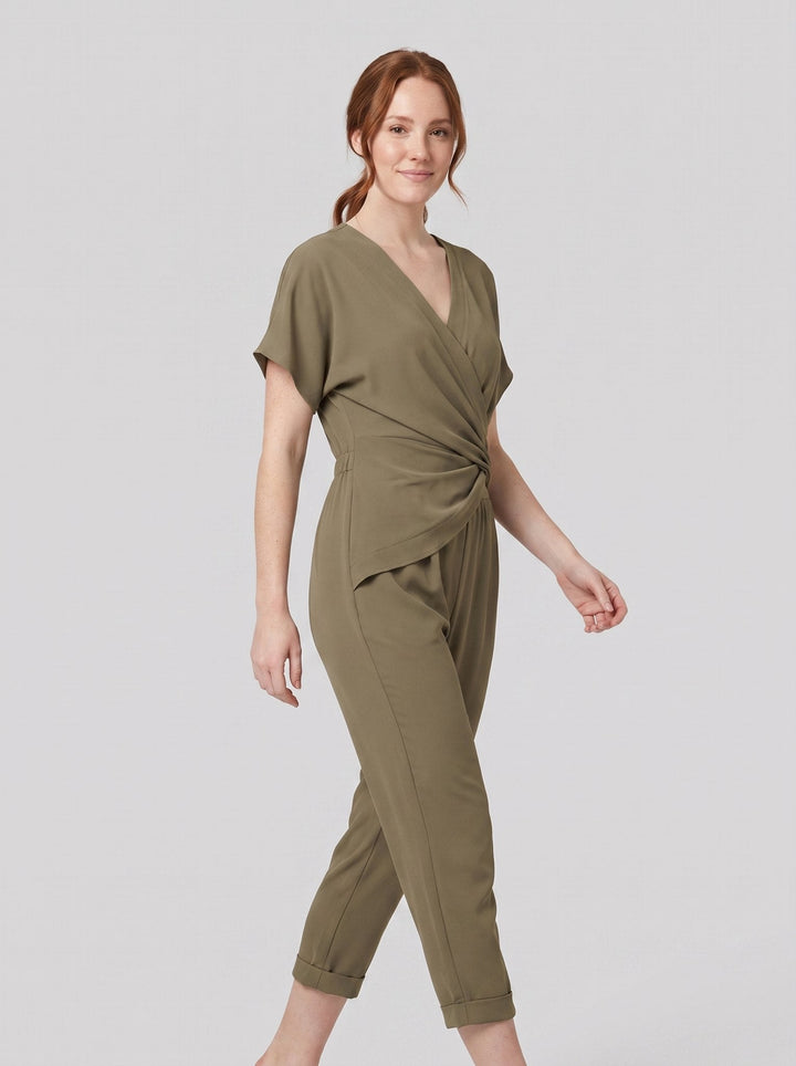 Lyra draped knot jumpsuit in olive green, wrap V-neck with knotted waist, on model