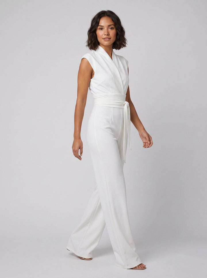 Malin Tassou chic sleeveless overall in white with wrap tie belt, on model
