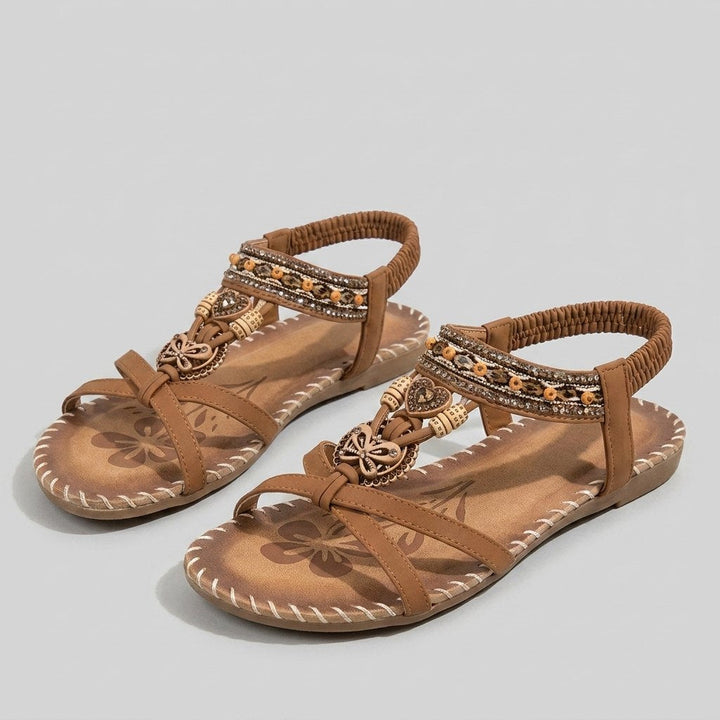 Brown beaded flat sandal with elastic heel strap, front view