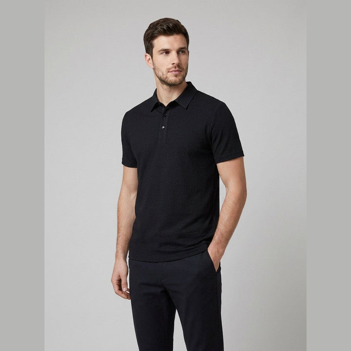 Black short-sleeved golf polo shirt, front view on model