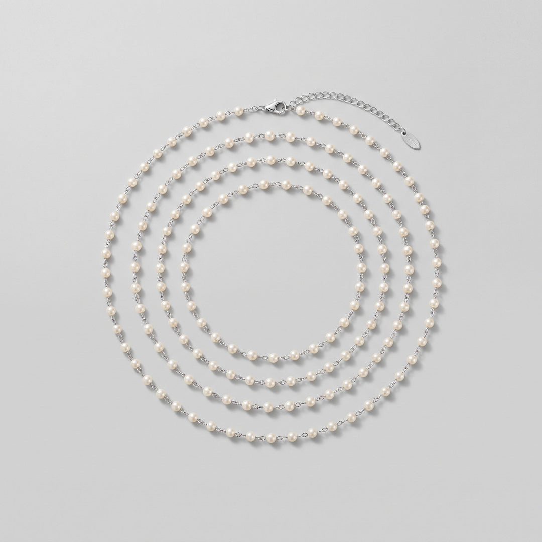 Ivory pearl body chain coiled, showing full length