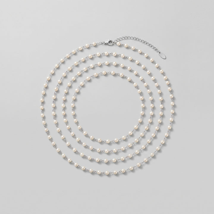 Ivory pearl body chain coiled, showing full length
