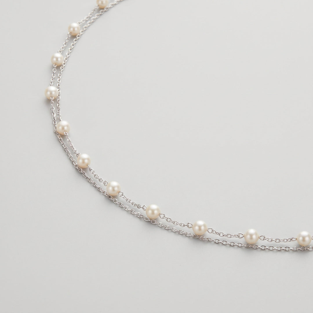 Ivory pearl body chain draped, showing pearl spacing