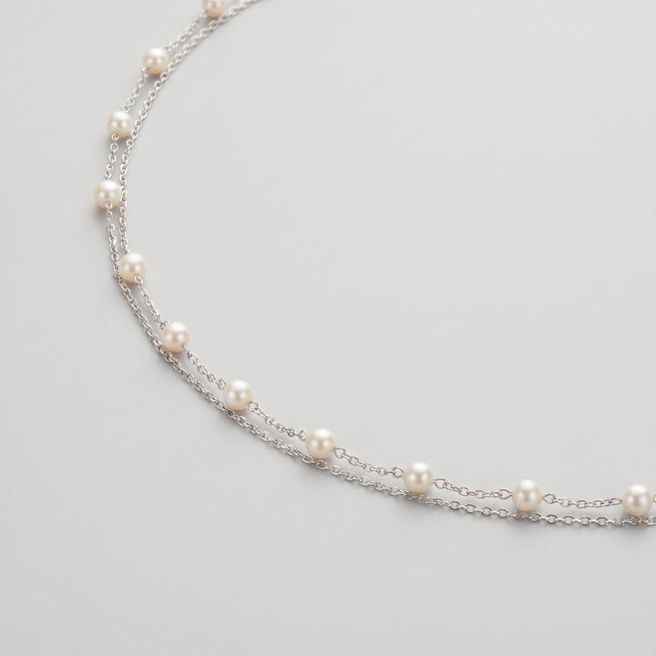 Ivory pearl body chain draped, showing pearl spacing