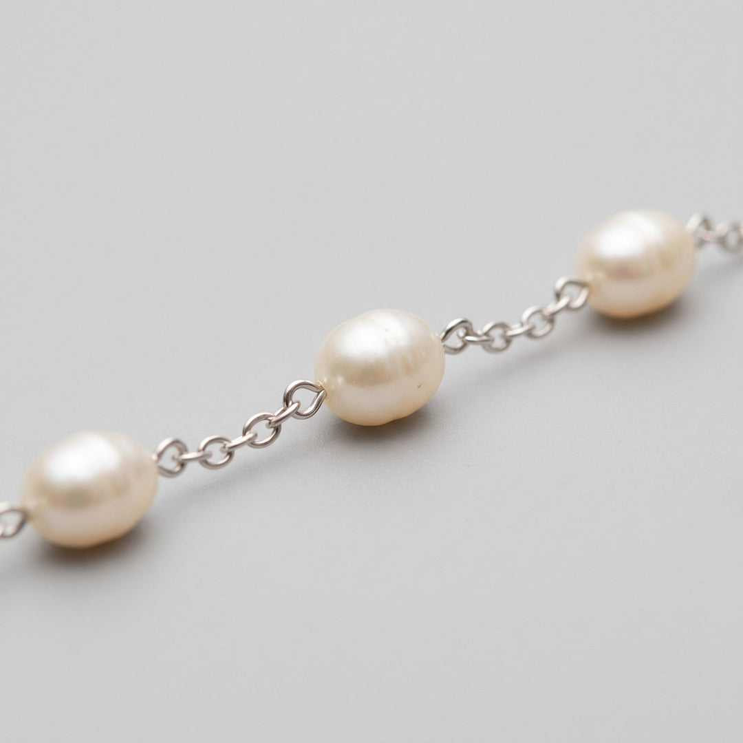 Freshwater pearl and fine chain link close-up detail
