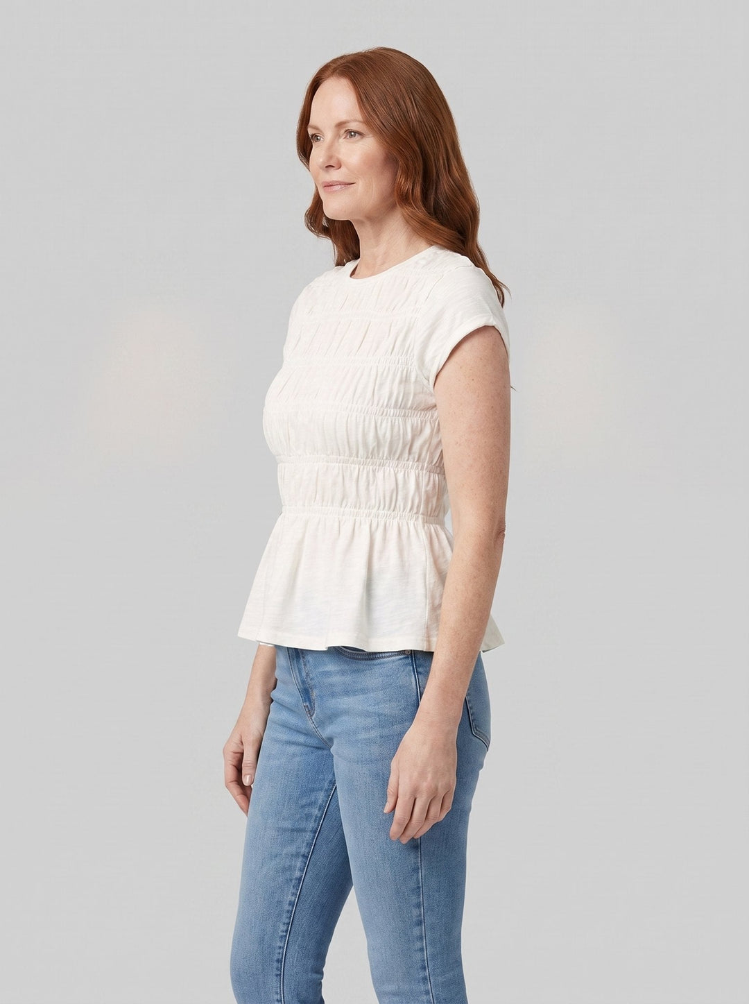 Rita ruffle top in white, side view