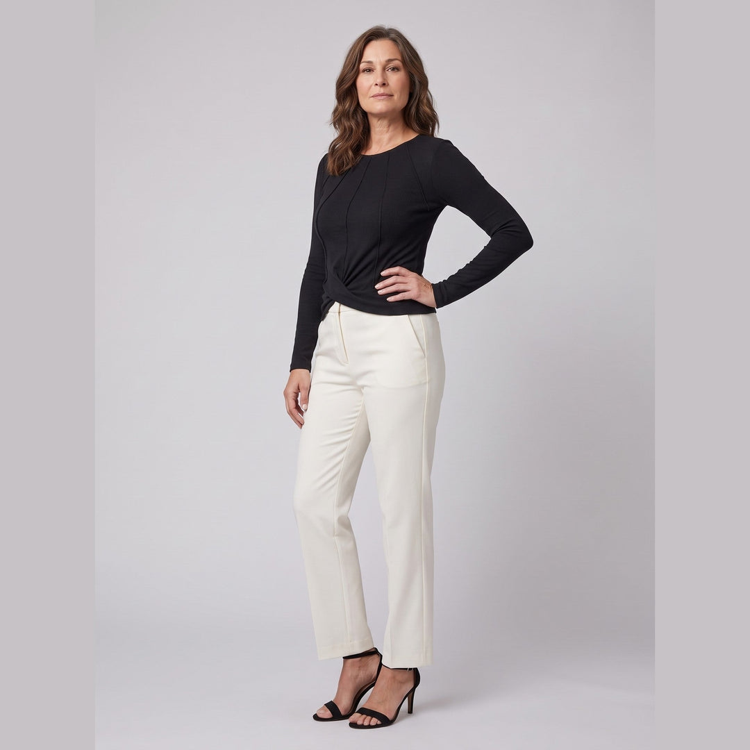 Black ribbed knit long sleeve top with twist front hem, three-quarter pose on model