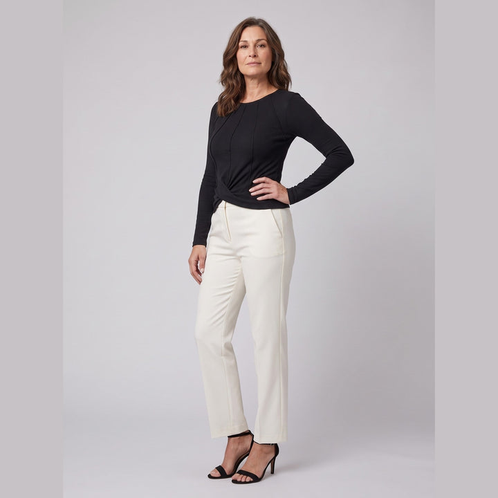 Black ribbed knit long sleeve top with twist front hem, three-quarter pose on model