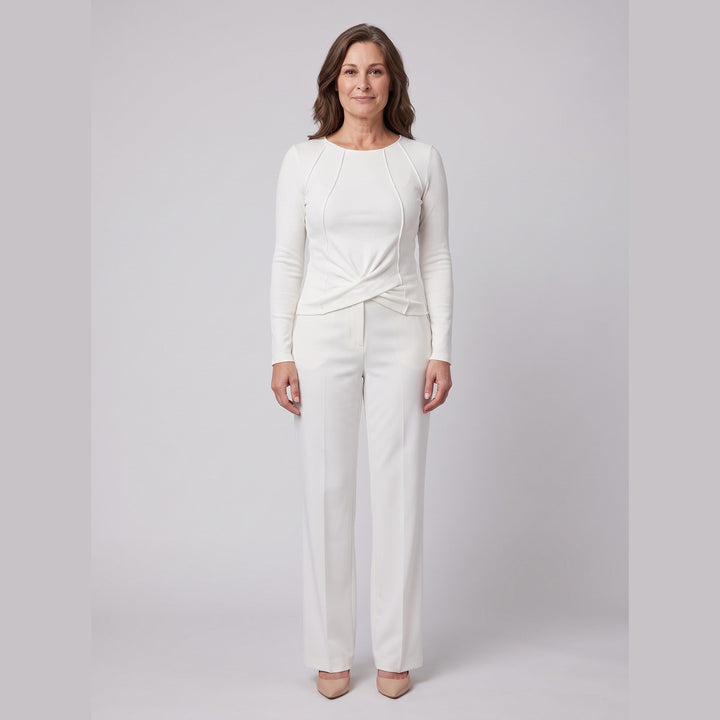 Ivory ribbed knit long sleeve top with twist front hem, front view on model