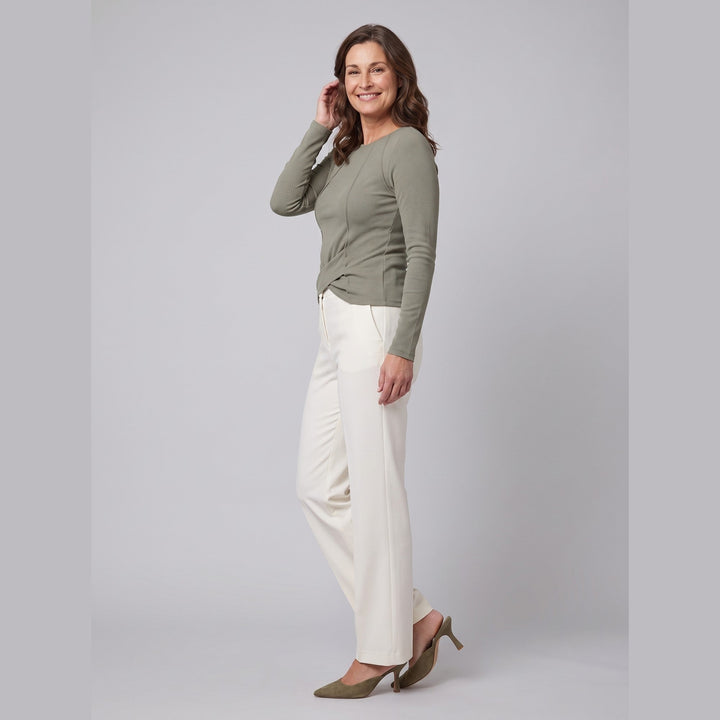 Olive green ribbed knit long sleeve top with twist front hem, side profile on model