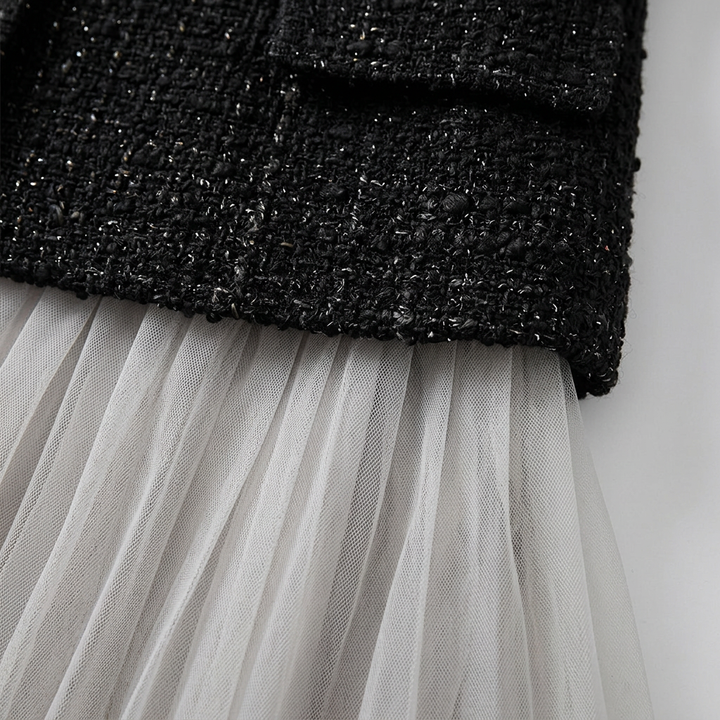 Close-up of the textured tweed and the fine tulle pleating