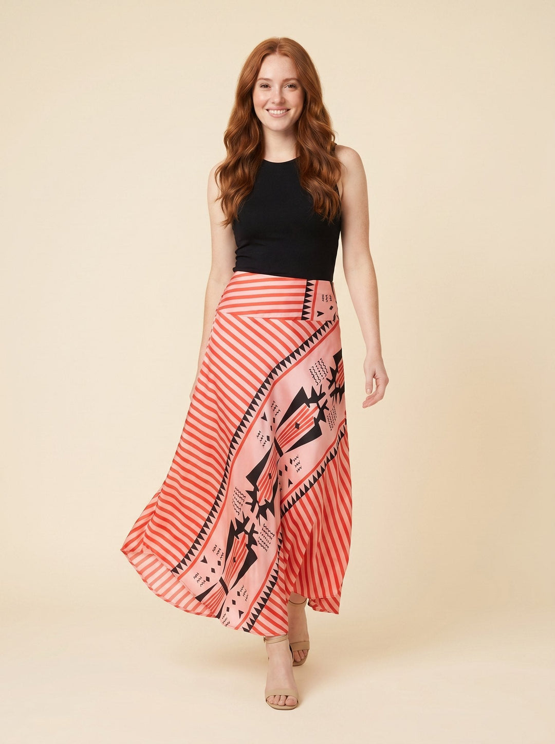 Red satin maxi skirt with geometric print, front view on model