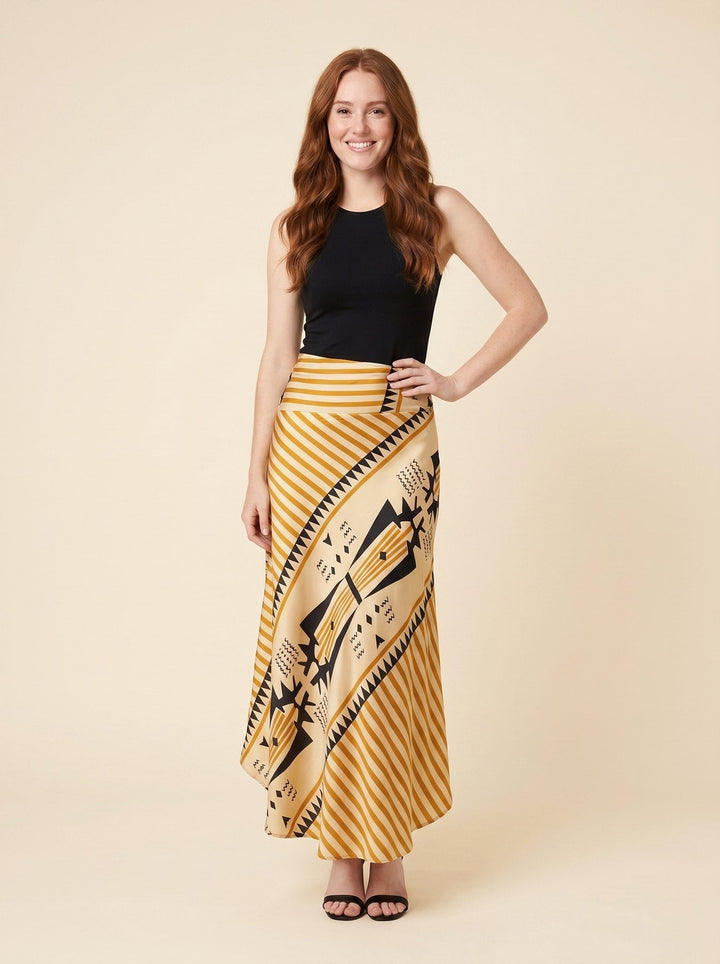 Yellow satin maxi skirt with geometric print, front view on model