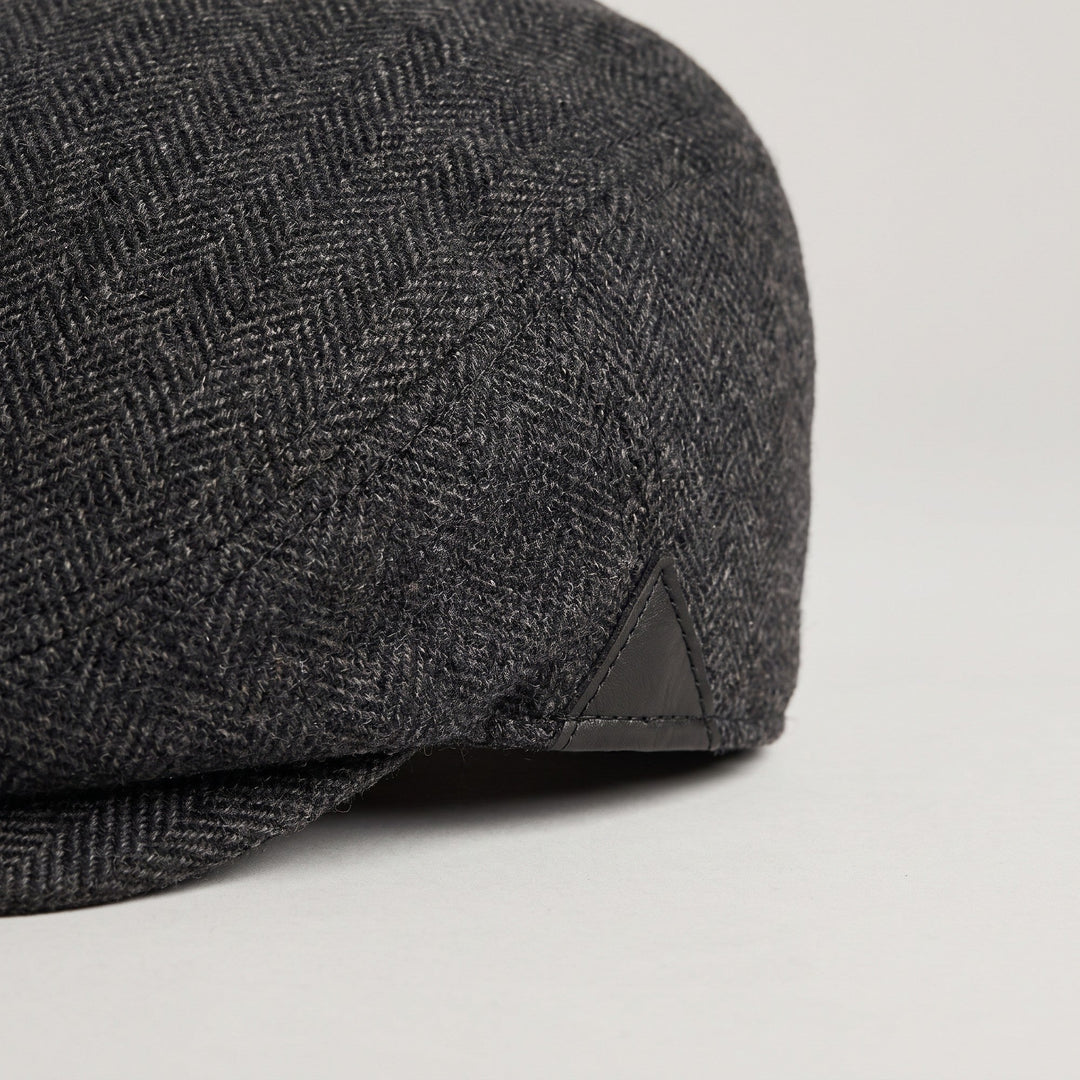 Herringbone wool weave and leather side patch close-up