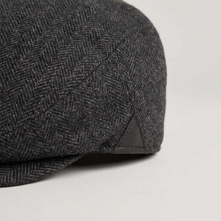 Herringbone wool weave and leather side patch close-up